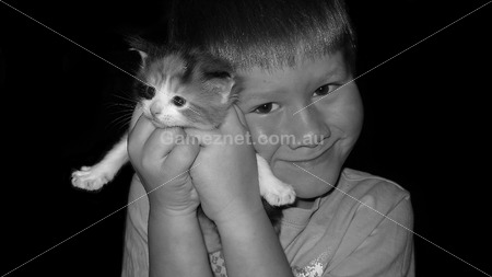 boy holding kitten – black and white