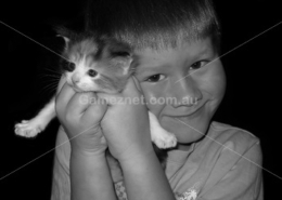 boy holding kitten – black and white - Gameznet Royalty Free Stock Media